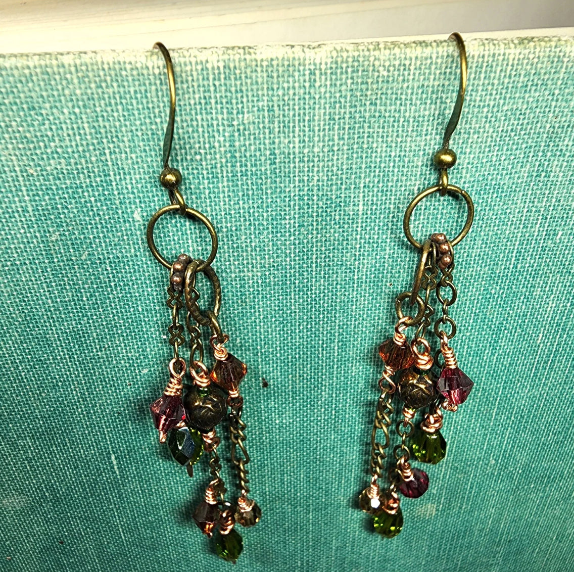 Earrings: cascade of antiqued brass chain with rose, olive, rust, brown faceted glass. 2.5 inch drop CL E2