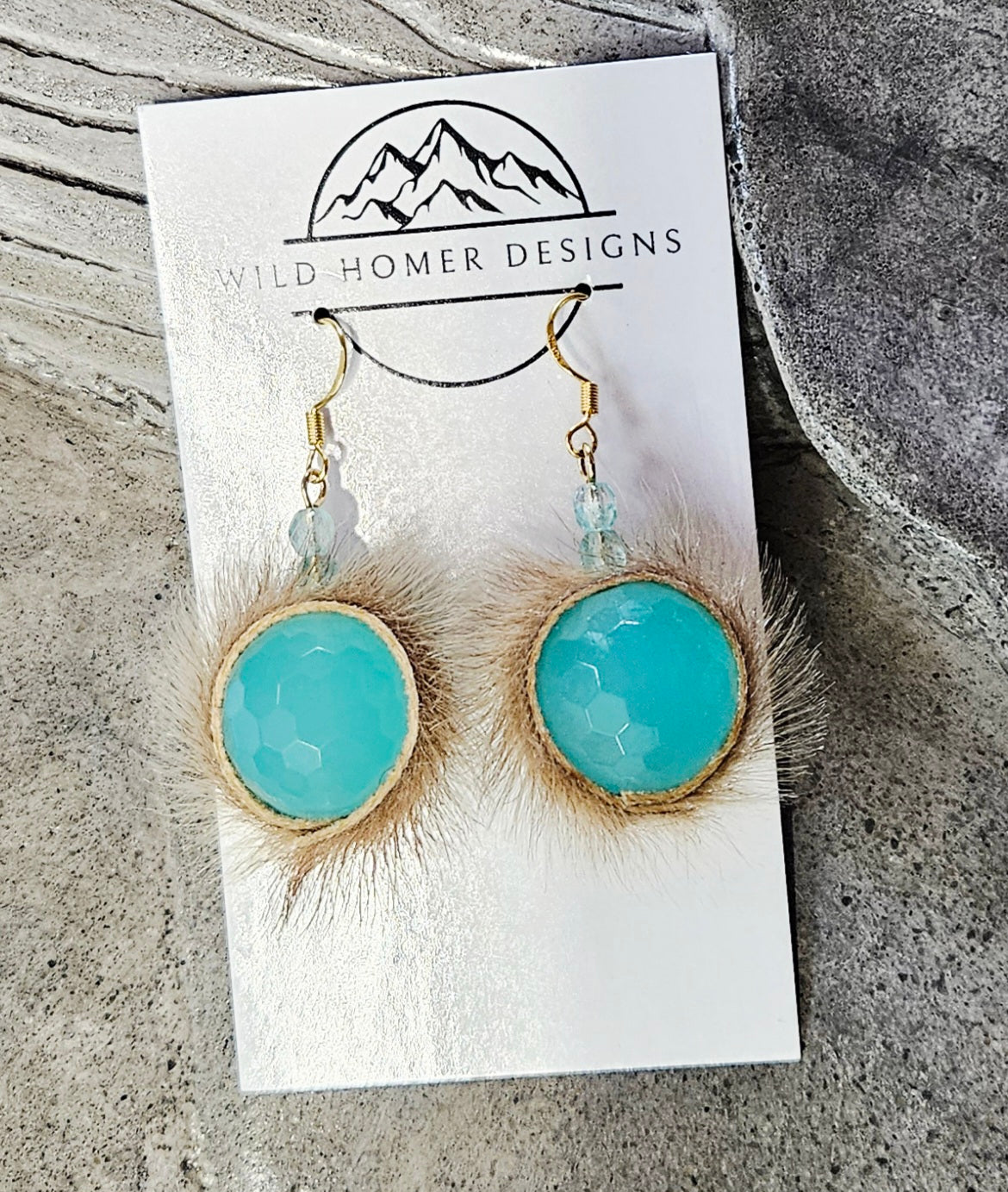 Seal skin earrings with blue glass beads