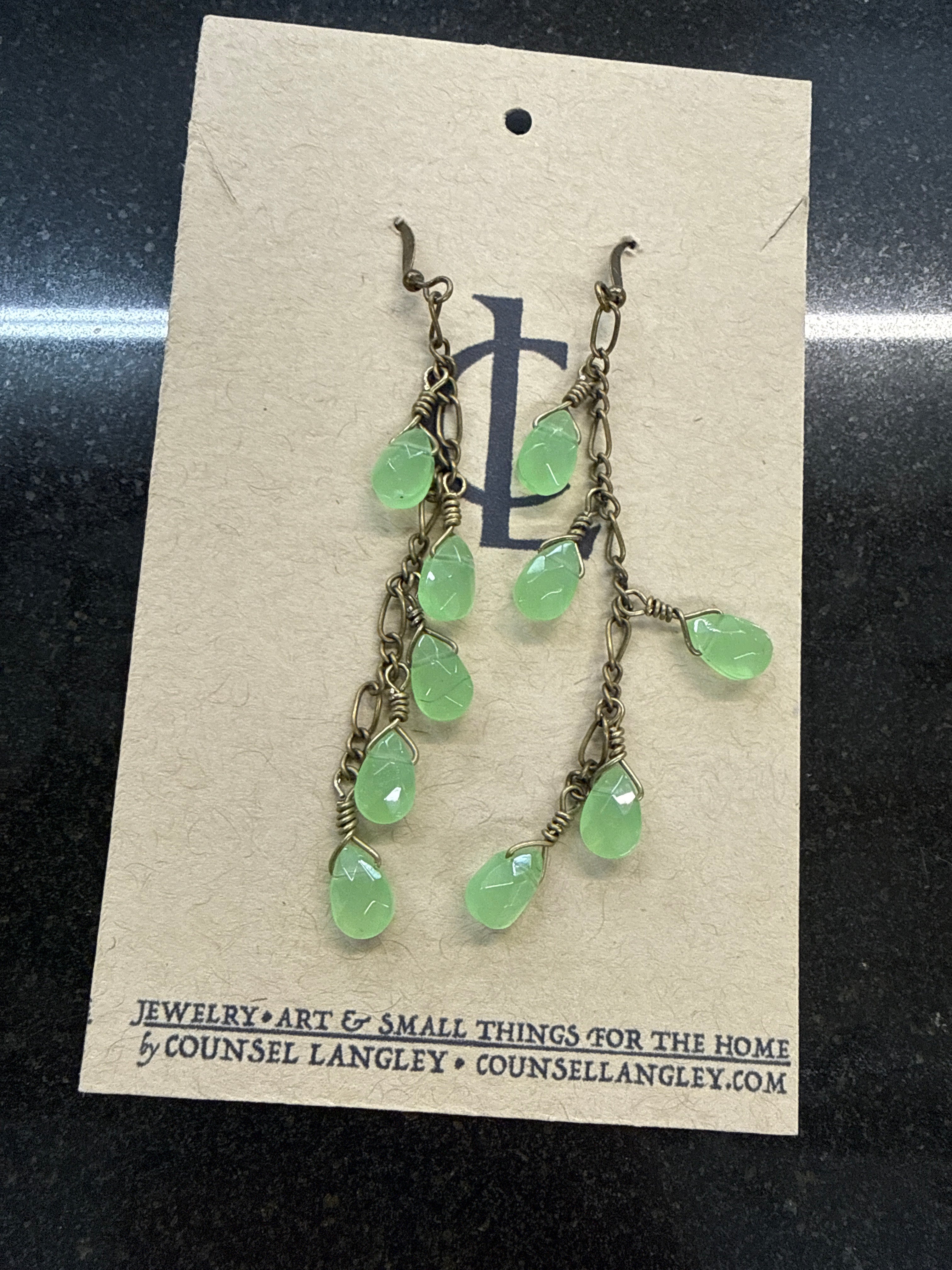 Earrings: Brass antiques chain with soft green beads. E18