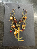 Earrings: Red Czech glass beads with vintage faux pearls on antiqued brass chain. E24