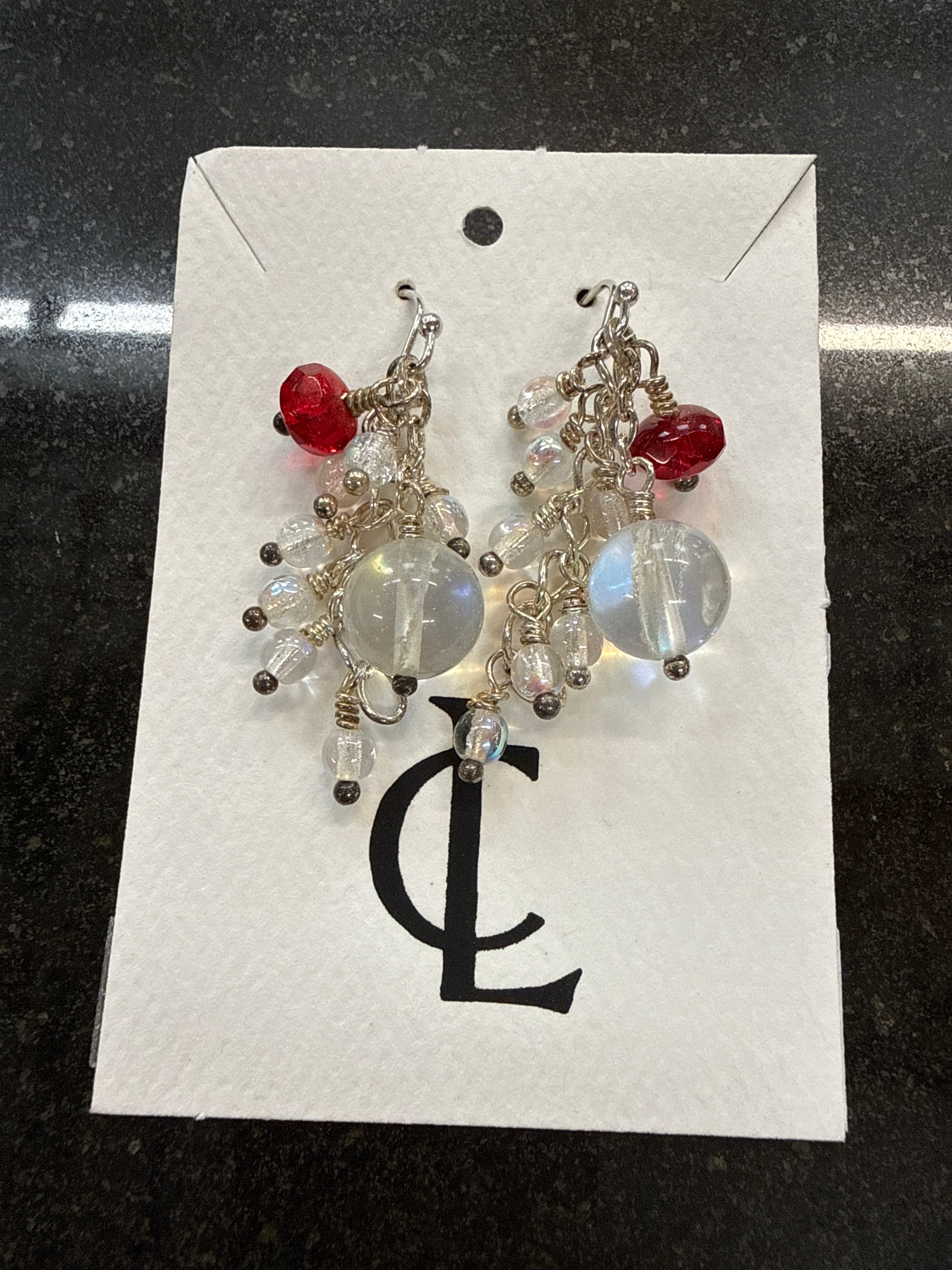 Earrings: Red clear opalescent glass beads on antiqued steel chain.  E7