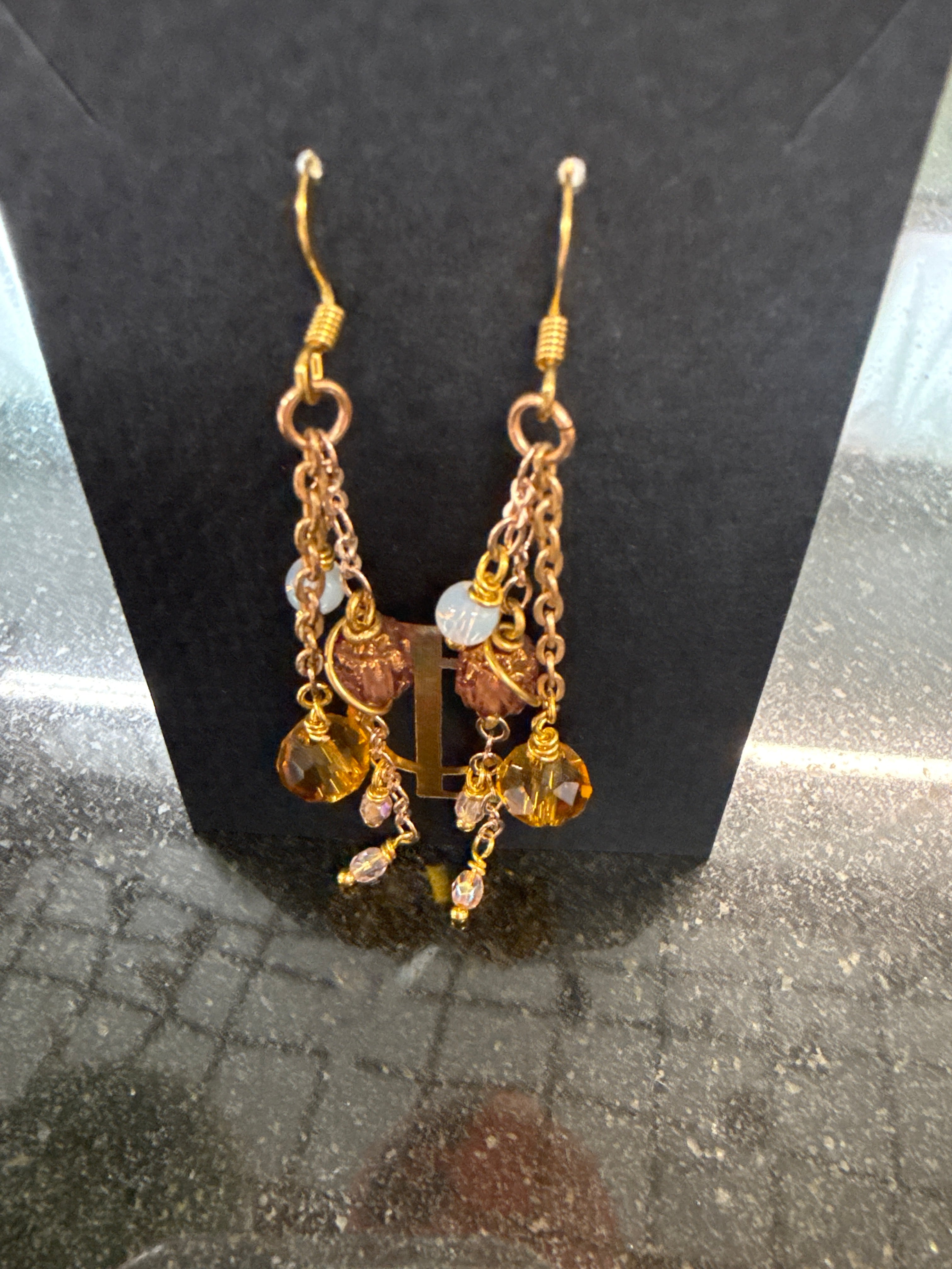 Earrings: Lavender Czech beads with opalescent, browns and clear beads. Brass. E27